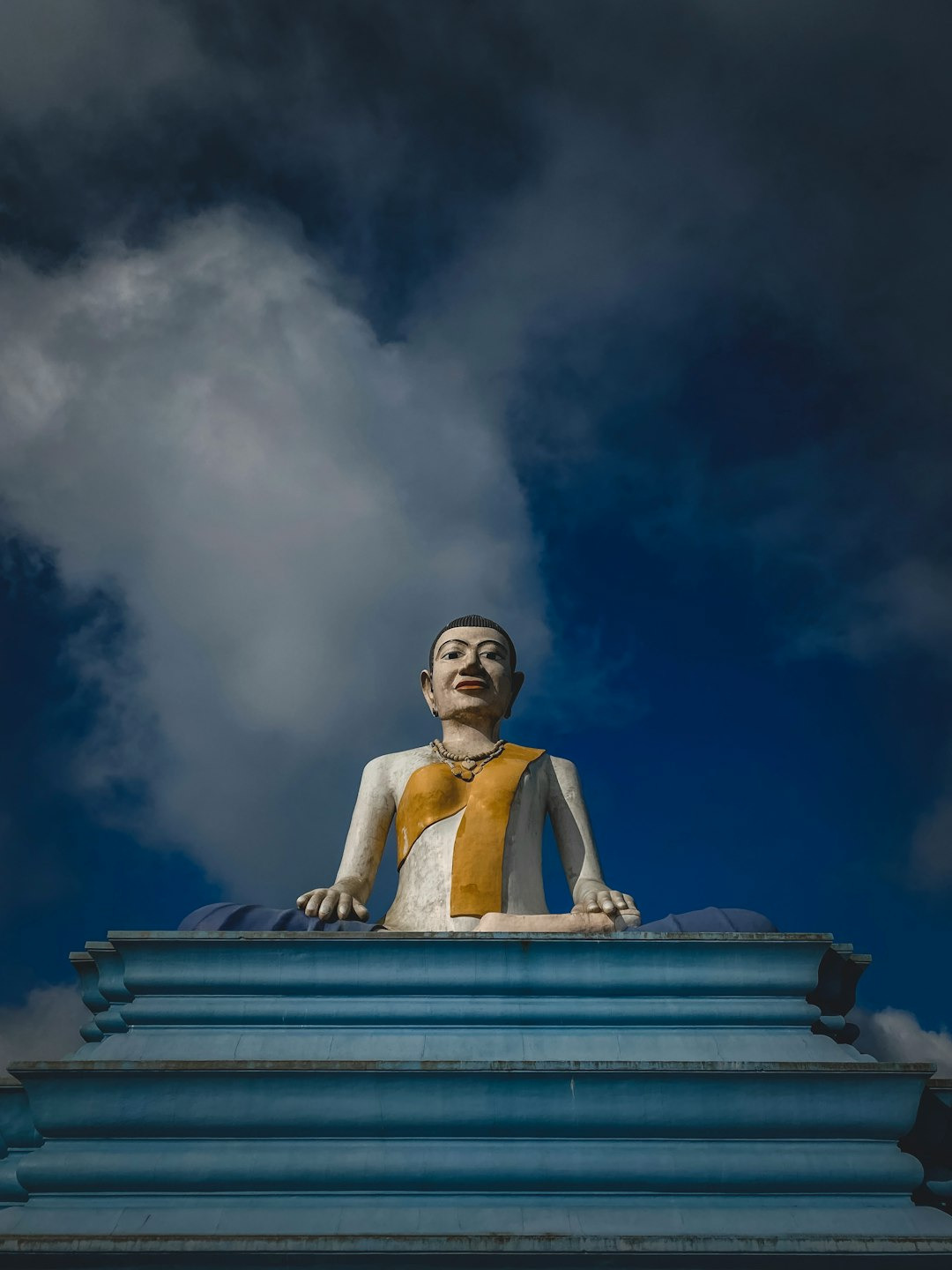 white concrete statue under cloudy sky during daytime